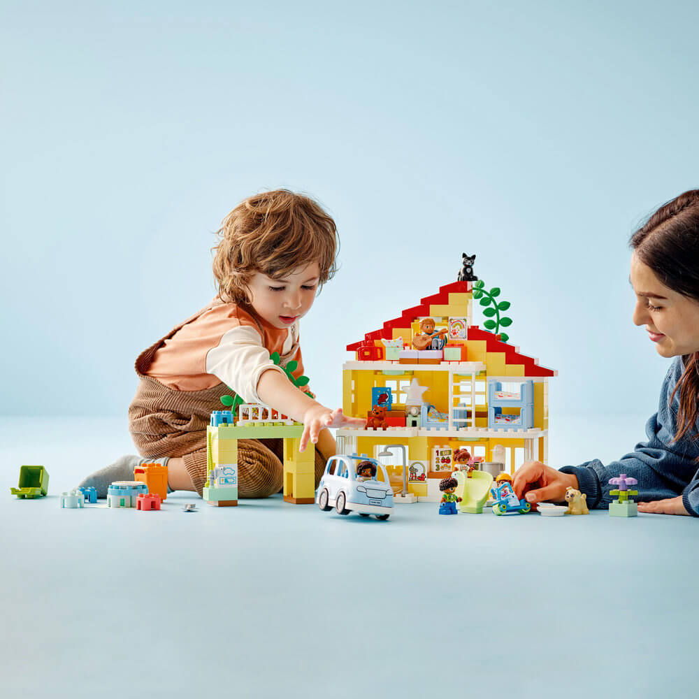 Child and adult playing with the LEGO® DUPLO® Town 3in1 Family House 10994 Building Toy Set (218 Pieces)