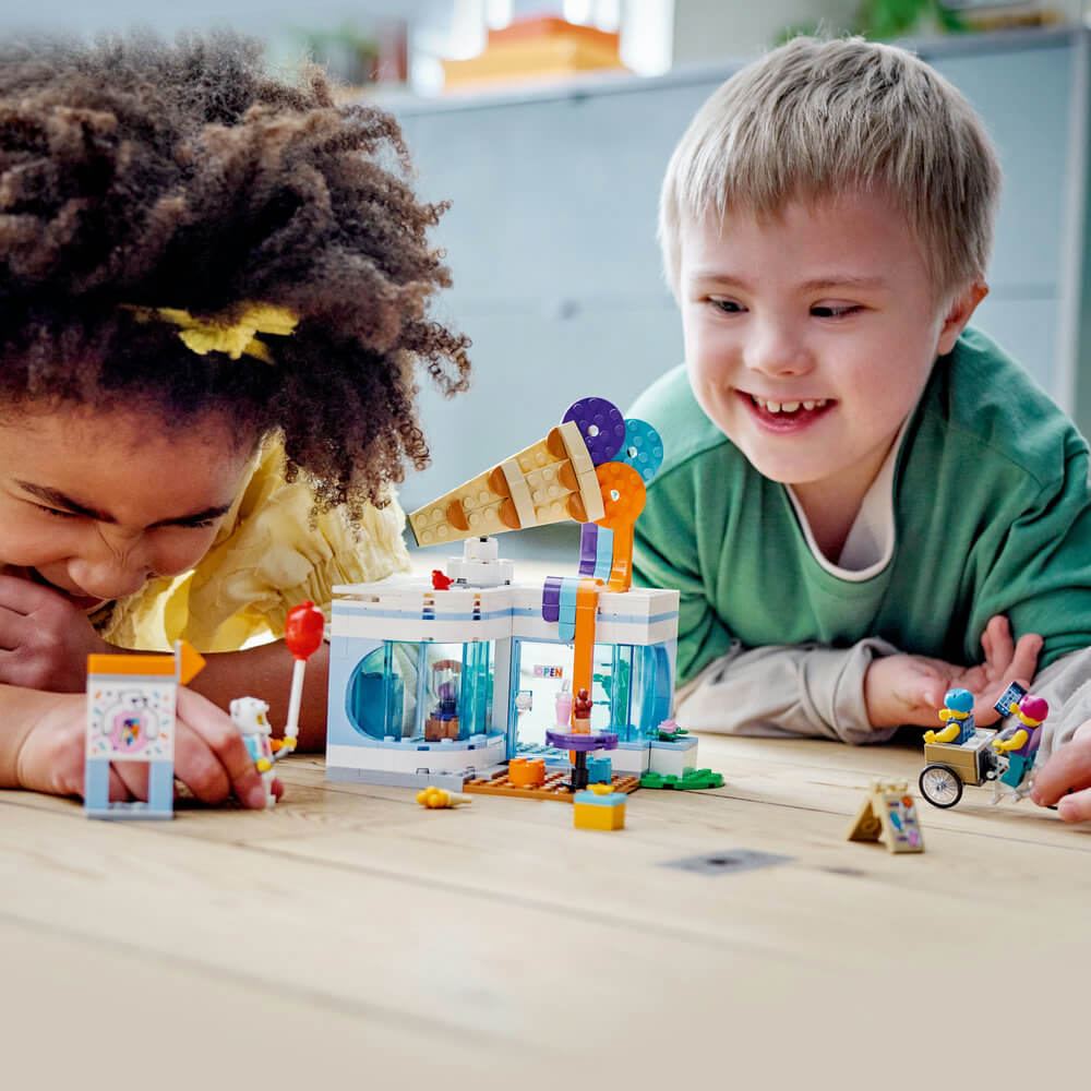 Two children playing with the LEGO® City Ice-Cream Shop 60363 Building Toy Set for Kids Aged 6+ (296 Pieces)