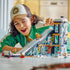 Child playing with the LEGO® City Ski and Climbing Center 60366 Building Toy Set (1,054 Pieces)