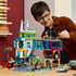 Child playing with the completed LEGO® City Downtown 60380 Building Toy Set (2,010 Pieces)