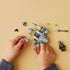 Two hands shown building the LEGO® Star Wars™ The Mandalorian’s N-1 Starfighter™ Microfighter 75363 (88 Pieces)