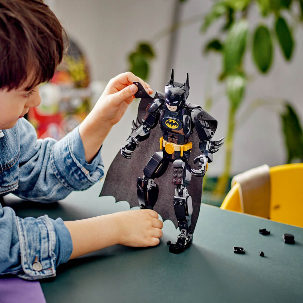 Kid playing with the cape of the LEGO® DC Batman™ Construction Figure 76259 Building Toy Set (275 Pieces)