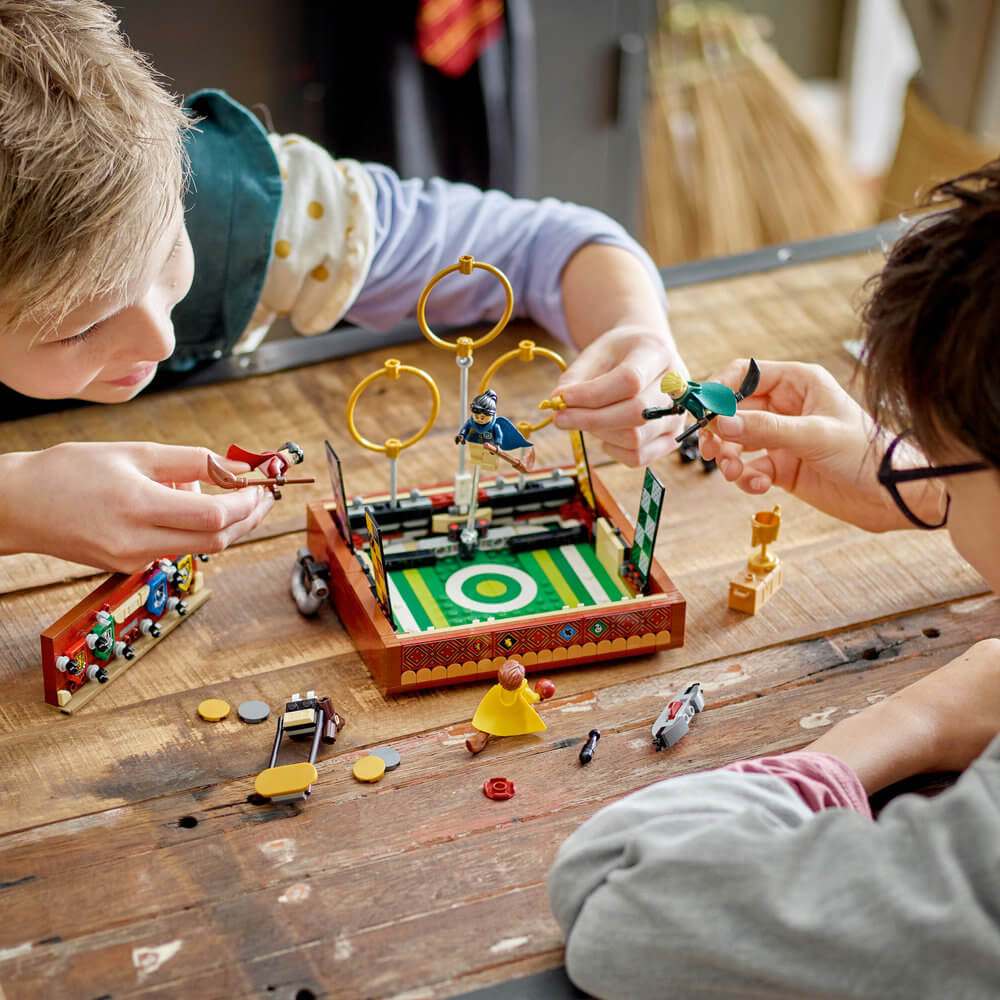 Two children playing with the LEGO® Harry Potter™ Quidditch™ Trunk 76416 Building Toy Set (599 Pieces)