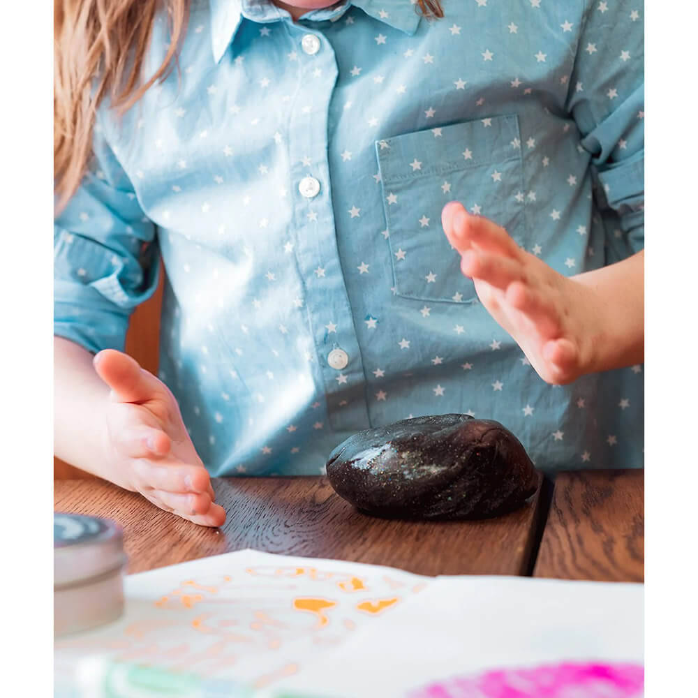 Child playing with the Crazy Aaron's Cosmic Glows Star Dust Thinking Putty 4