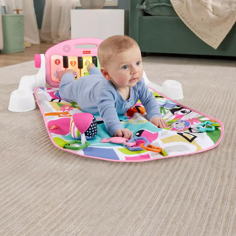 Baby crawling on the Fisher-Price Glow and Grow Kick & Play Piano Gym (Pink) with tummy time.