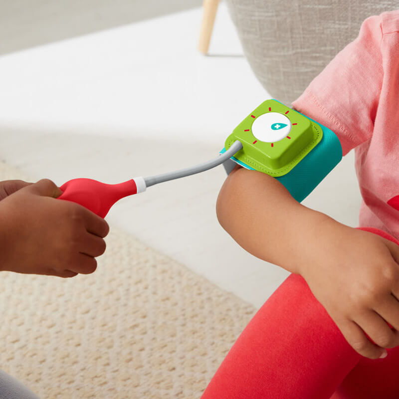 Girl pretending to take blood pressure with her new toy