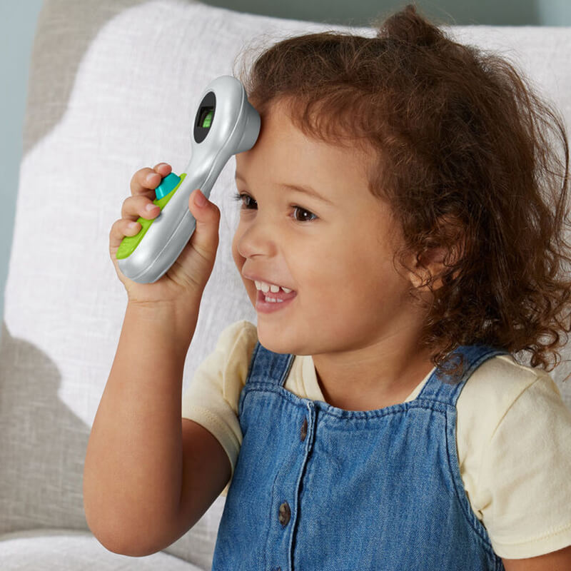 Girl playing with the thermometer from the Fisher-Price Medical Kit Role-Play Playset