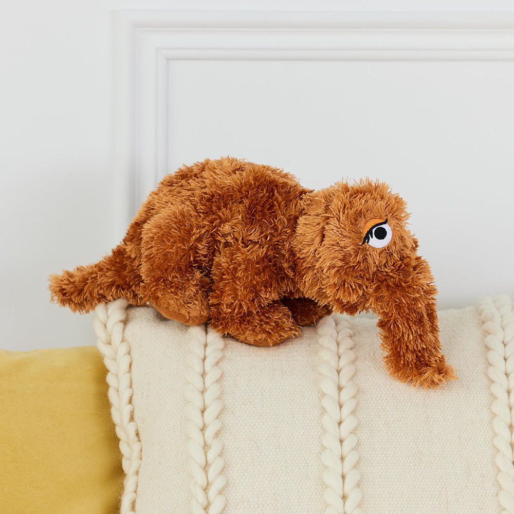 side view image of Sesame Street Snuffleupagus on top of pillow