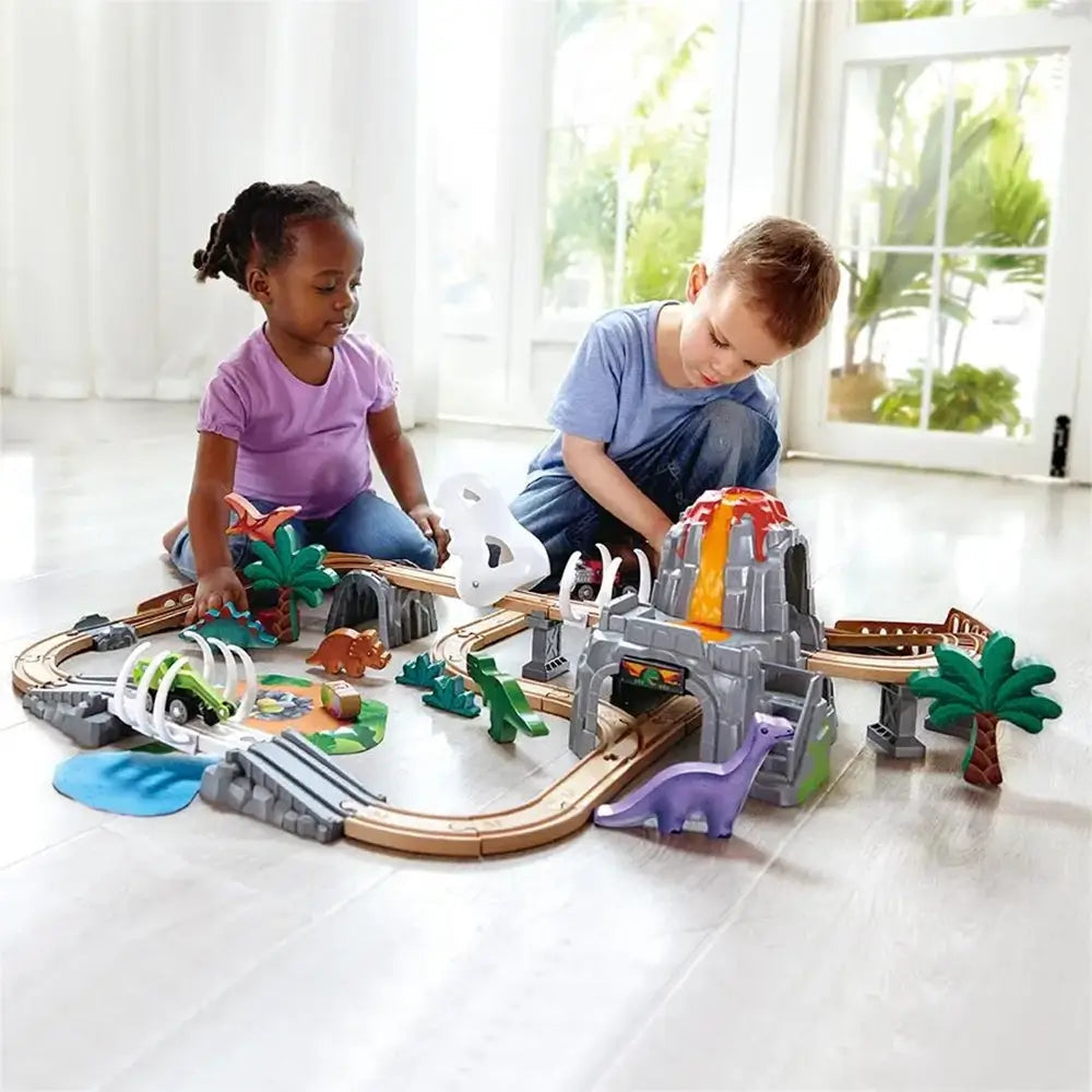 Boy and girl playing with the Hape Dinosaur Railway Adventure Train Set