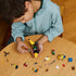 Boy wearing jacket playing lego 