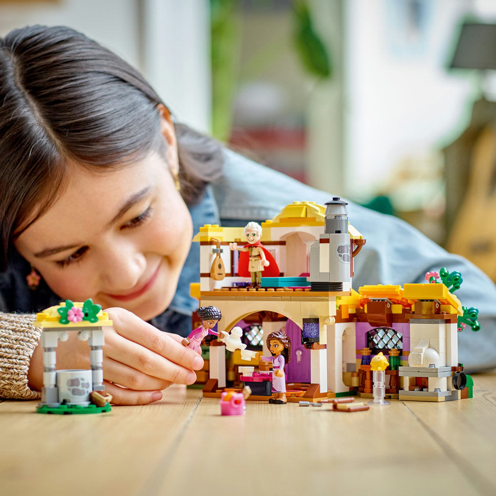 Closer picture of a girl playing LEGO® Disney Princess Wish Asha's Cottage set