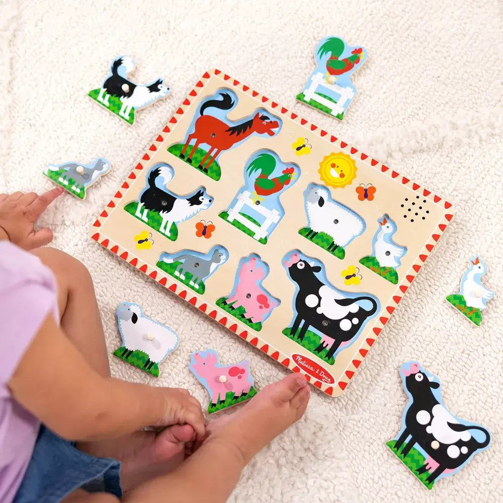 Toddler playing Melissa and Doug Farm Animals 8 Piece Sound Puzzle 