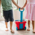 Boy and girl rolling the Melissa and Doug Fill & Roll Grocery Basket Play Set.