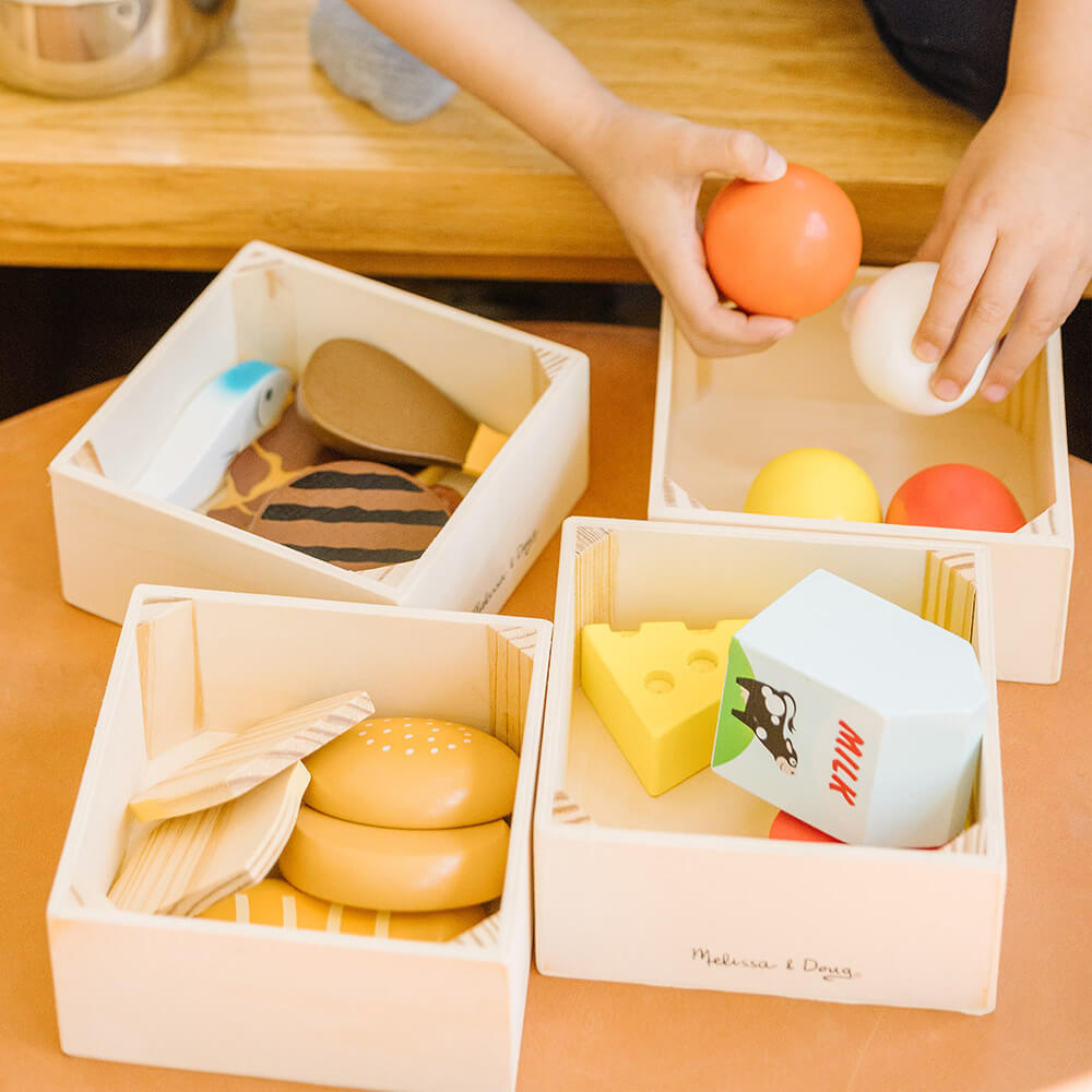 All four boxes and food open showing what comes with Melissa and Doug Food Groups Wooden Food Play Set 