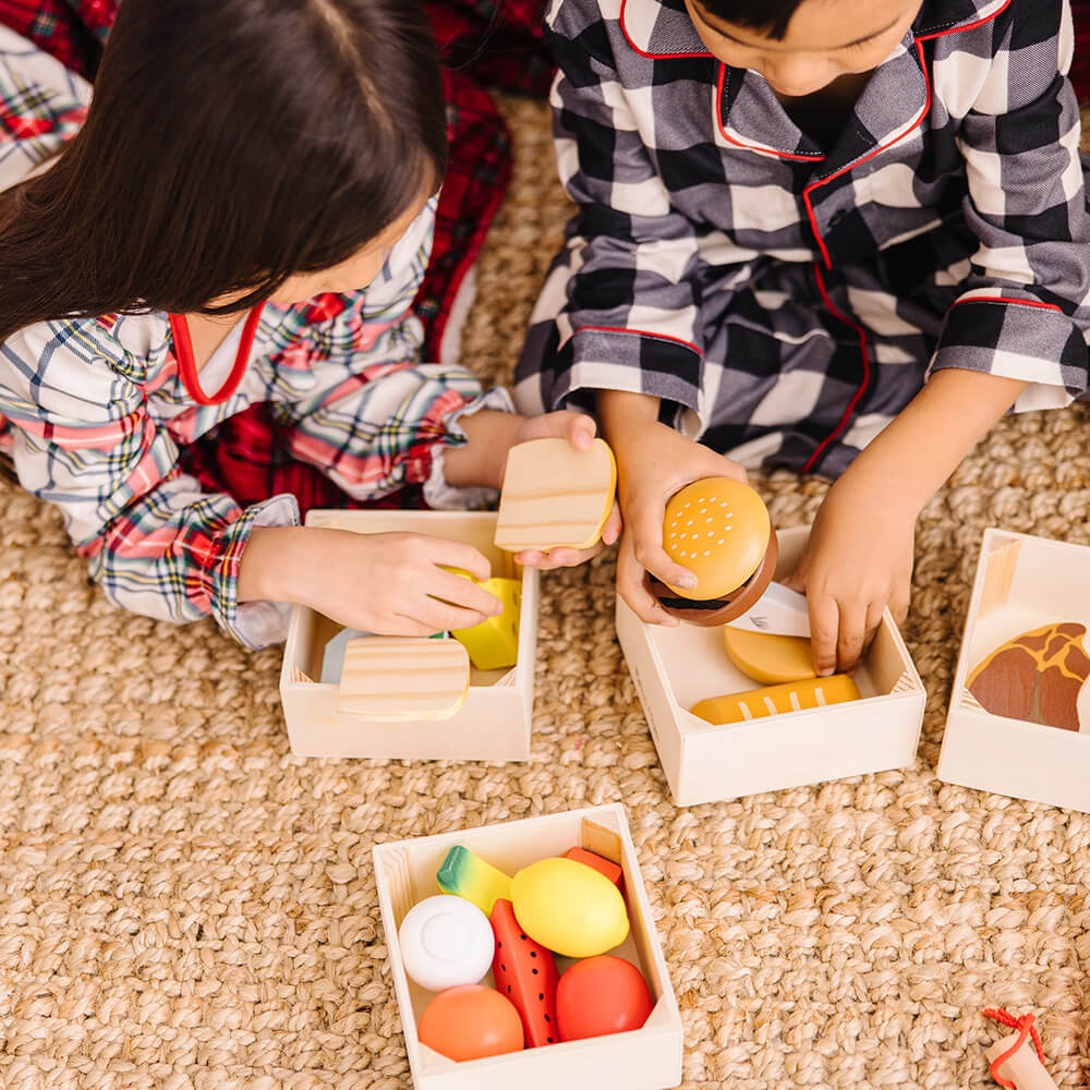 Boy and girl playing together with the Melissa and Doug Food Groups Wooden Food Play Set