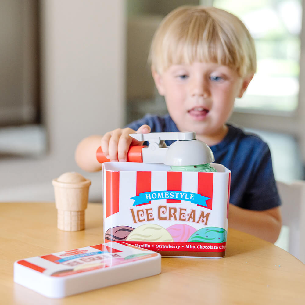 Little boy playing with the Melissa and Doug Scoop & Stack Ice Cream Cone Play Set