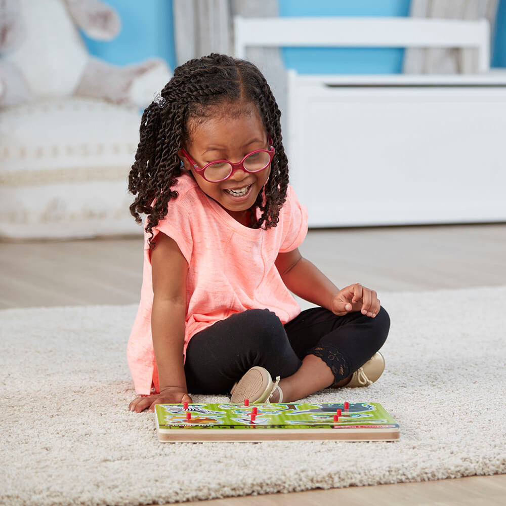 Little girls playing with the Melissa and Doug Zoo Animals 8 Piece Sound Puzzle on the floor