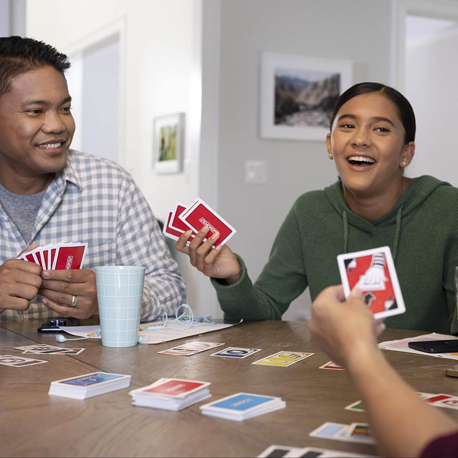 Friends playing the Monopoly Bid Card Game