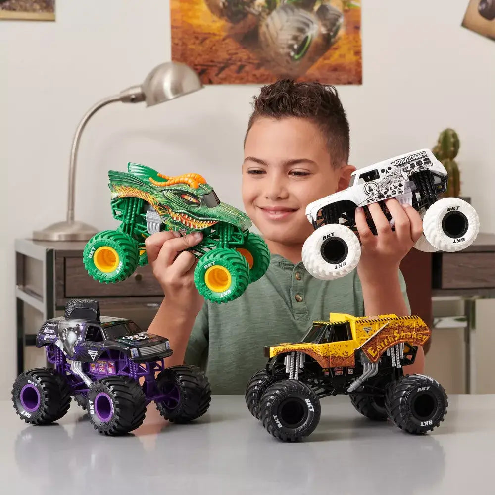 Boy playing with the Monster Jam Series 20 Dragon 1:24 Scale Diecast Monster Truck and other monster jam trucks (not included)