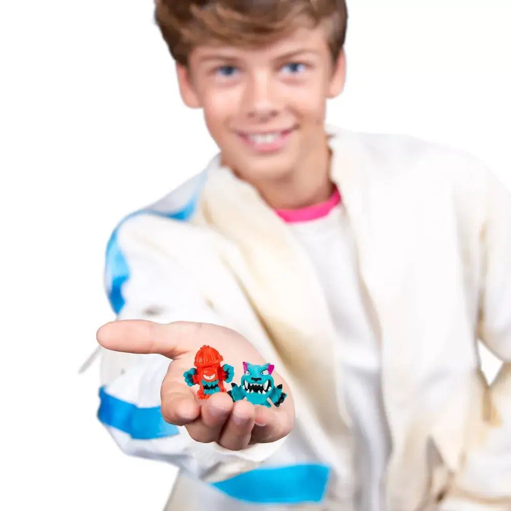 Boy holding up two collectible MrBeast Swarms figures.