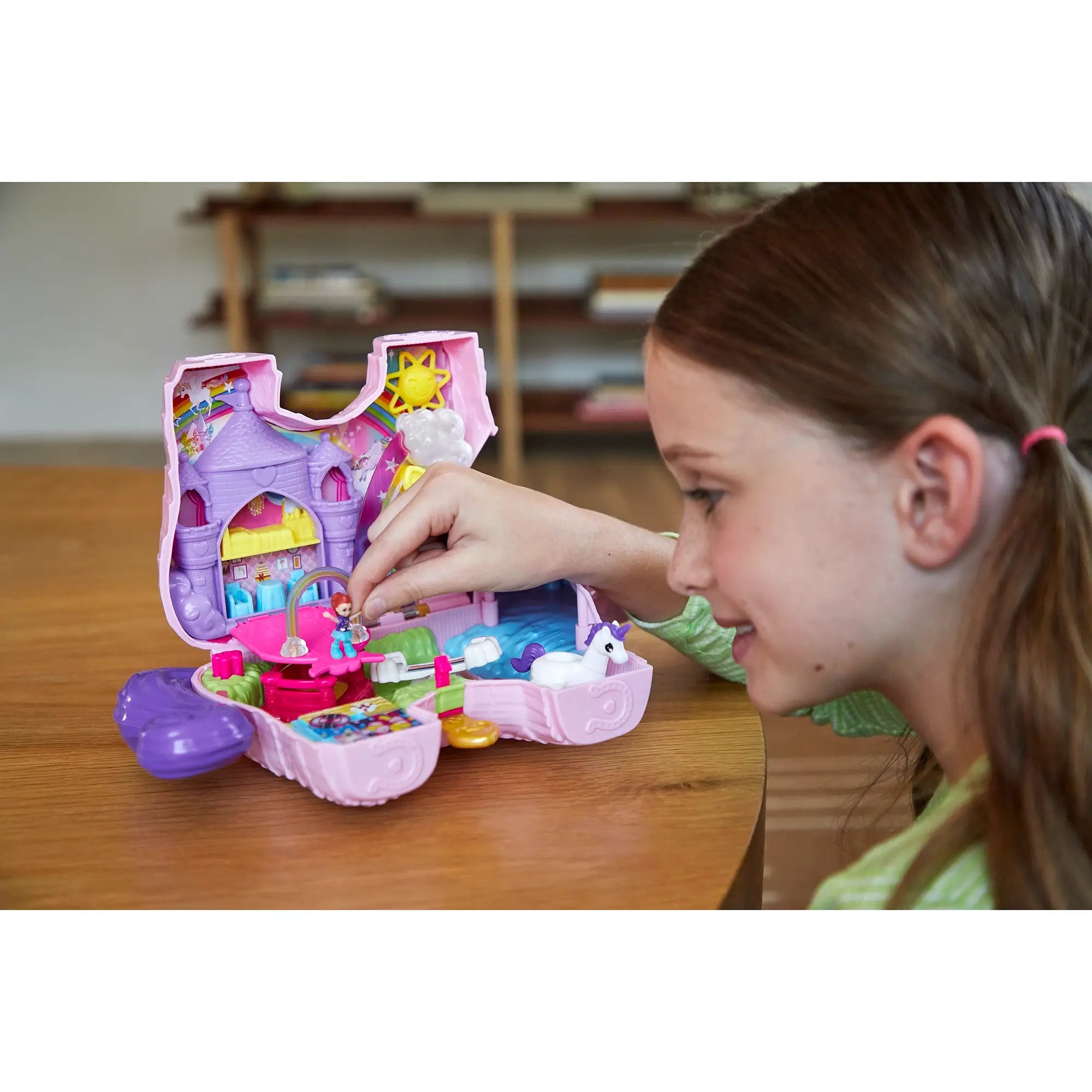 Polly Pocket 2-in-1 Unicorn Party Travel Toy girl playing with 