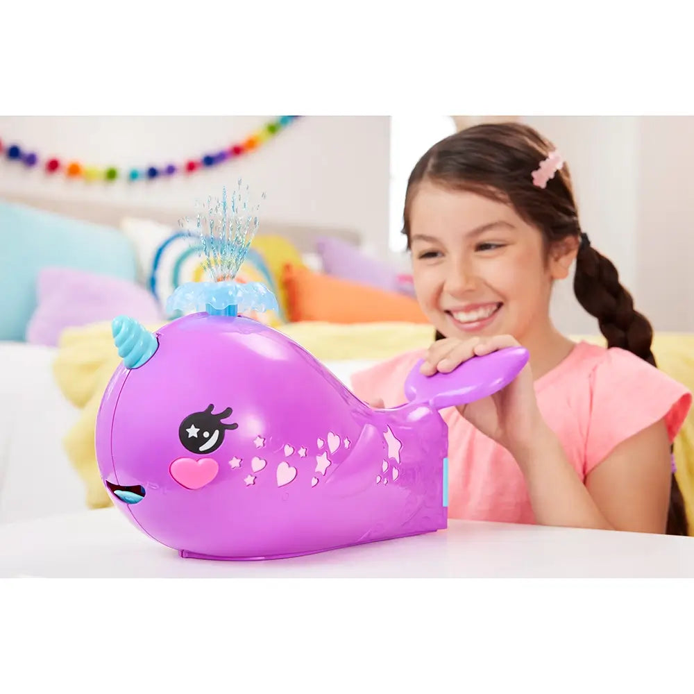 girl making the water shoot from the Polly Pocket Sparkle Cove Adventure Narwhal Adventurer Boat Playset