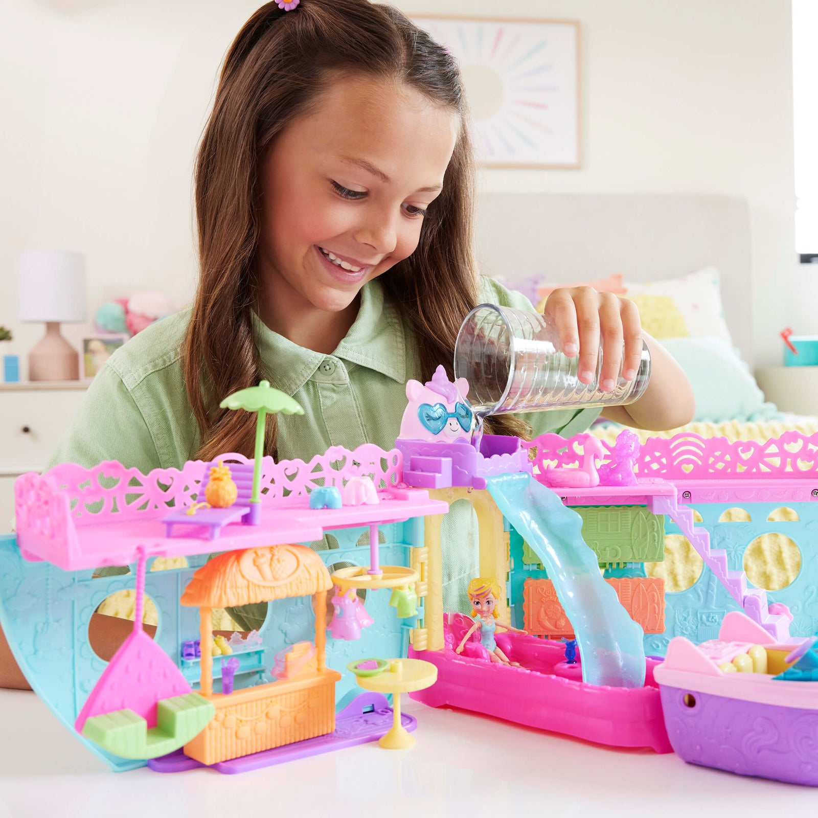 Girl playing with the Polly Pocket Unicorn Dream Cruise Playset