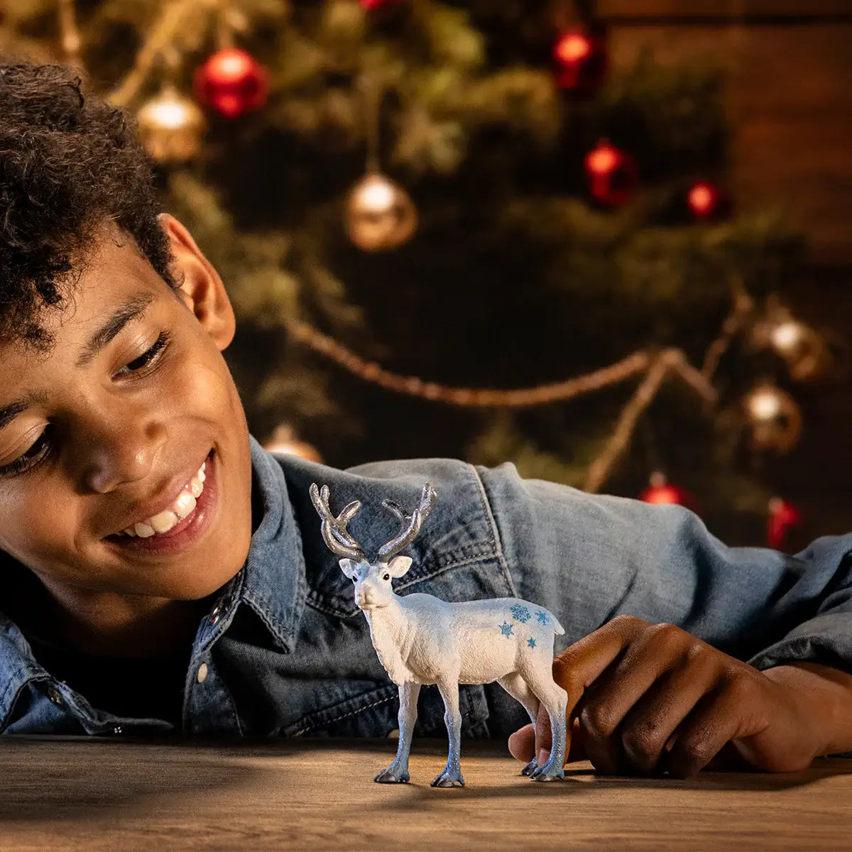 Schleich Limited-Edition Holiday Reindeer 2024 (72220) with boy