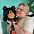 Woman holding the Squishable Mini Black Bear Plush