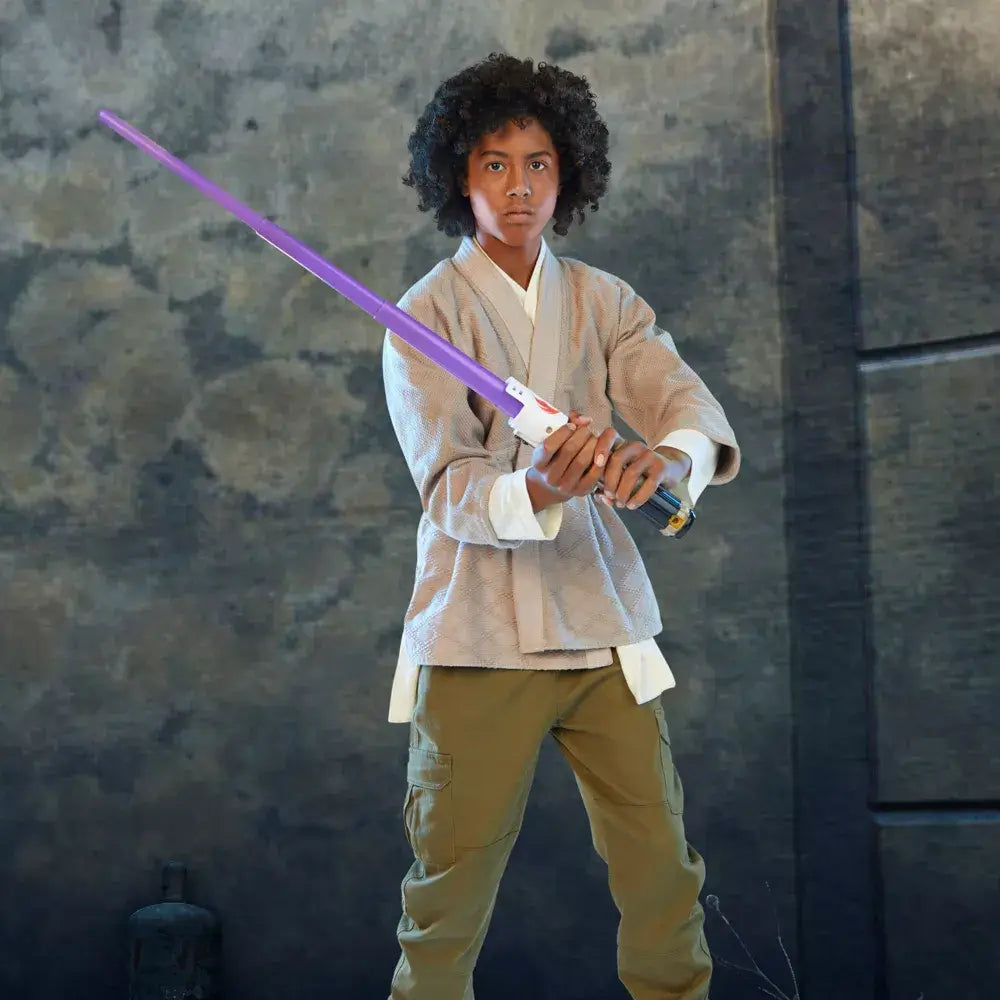 Boy posing in a defensive stance with the Star Wars Lightsaber Forge Mace Windu Extendable Purple Lightsaber