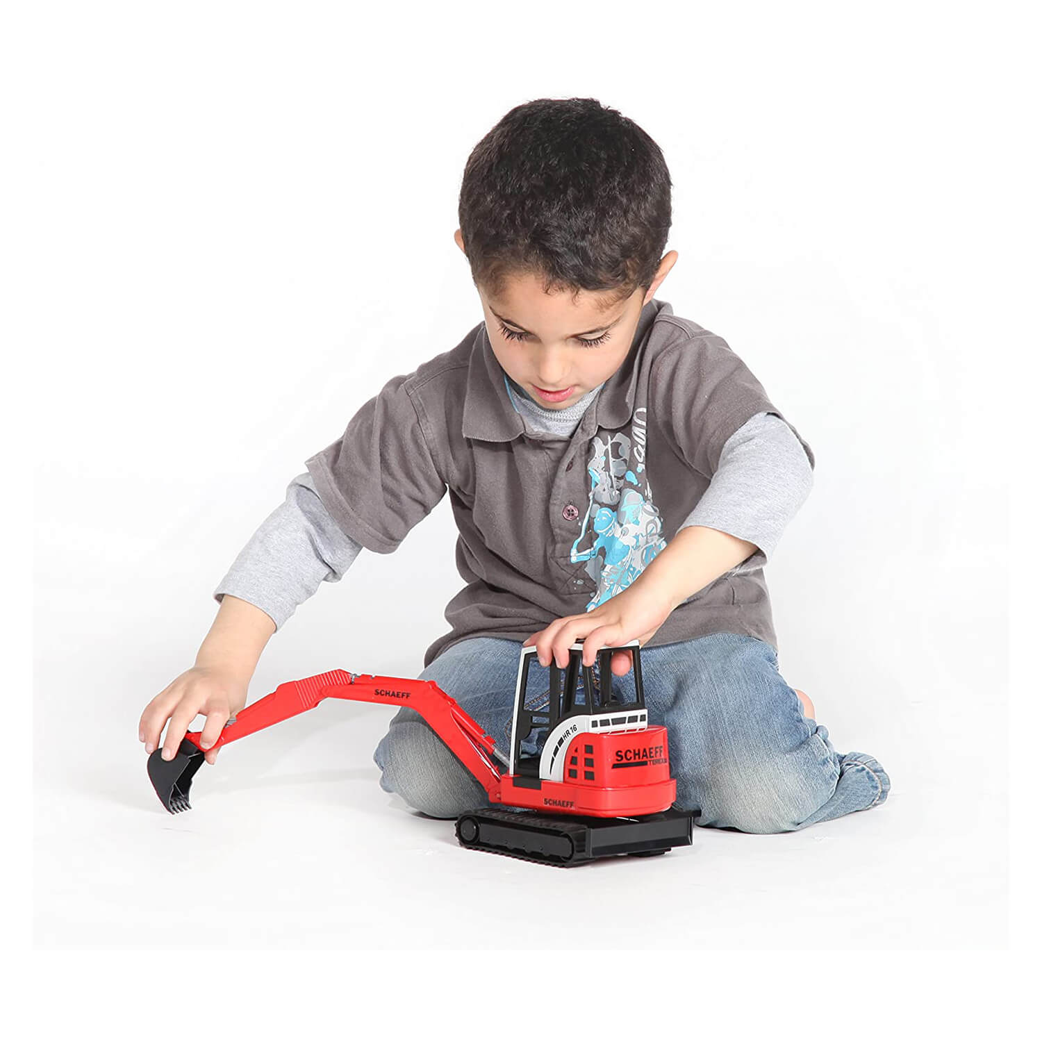 Boy playing with the Bruder Schaeff mini excavator