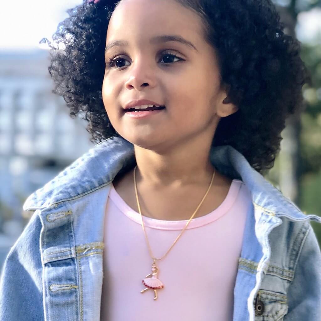 Front view of little girl wearing the Great Pretenders Ballet Beauty Necklace.