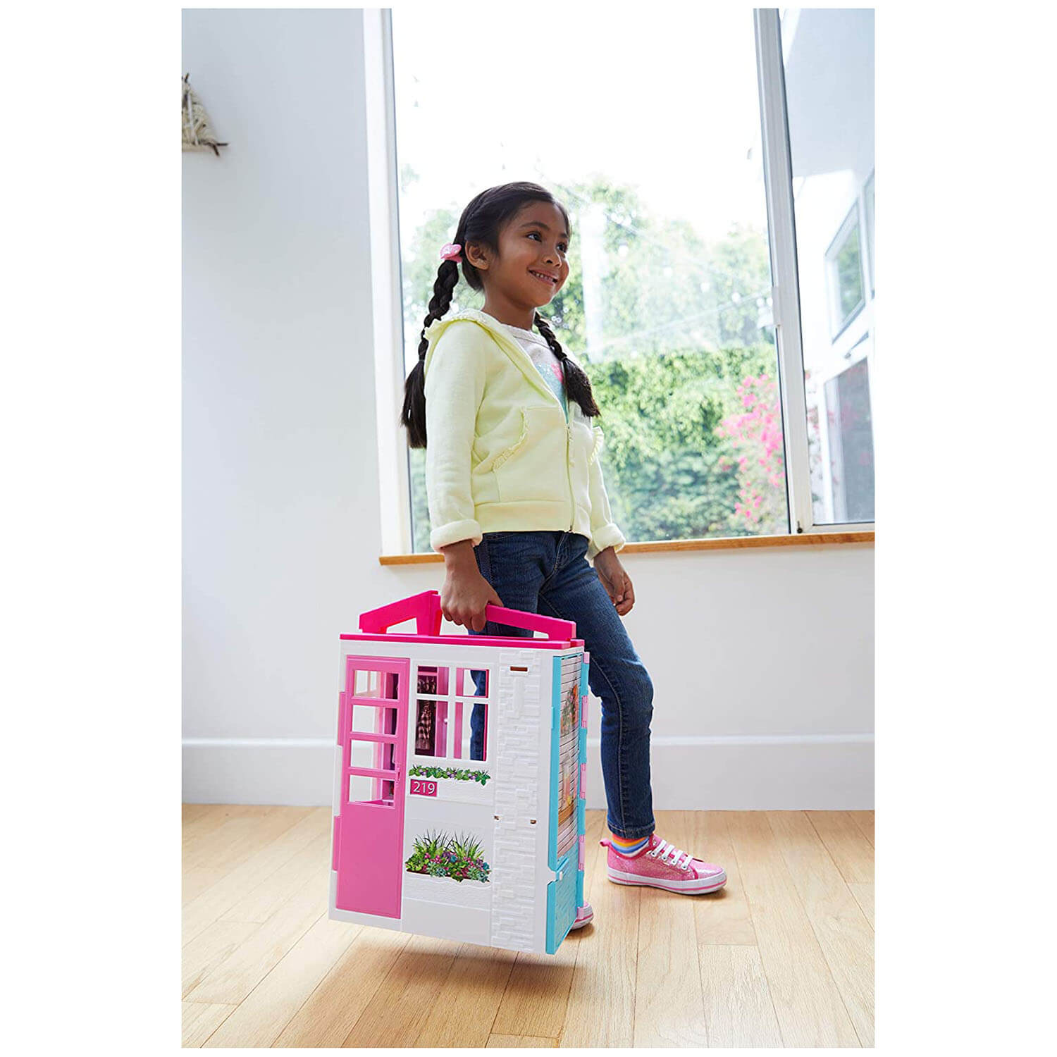 Kid playing with the barbie toy.